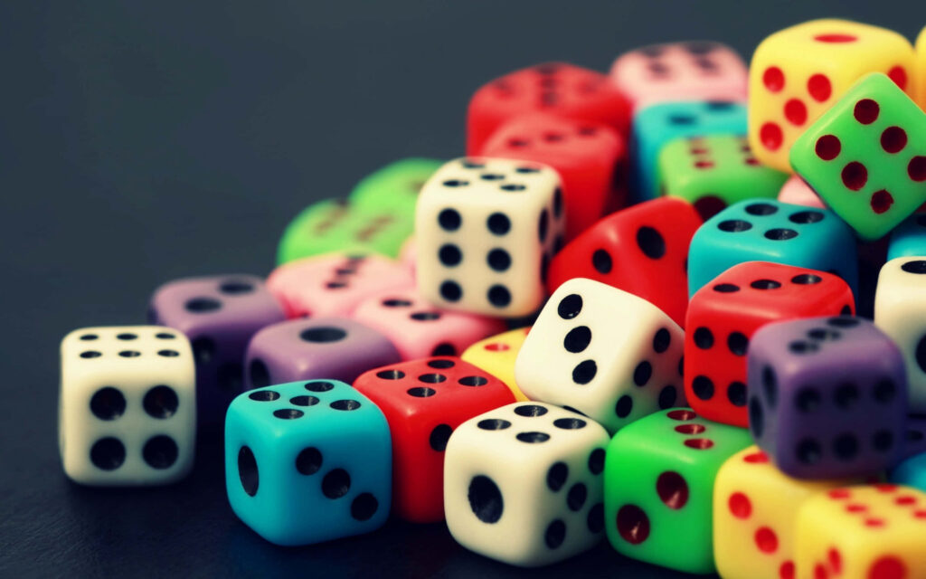 Colorful glossy dice scattered on dark background vibrant playful wallpaper background design