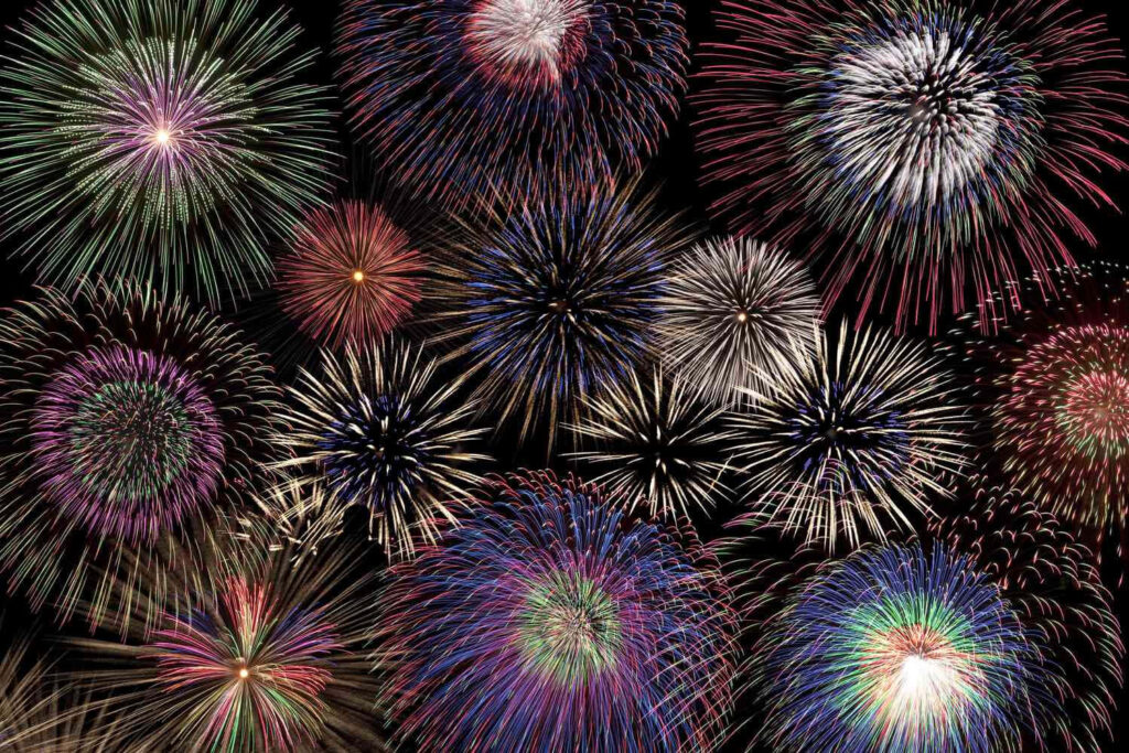 Colorful fireworks burst in night sky vibrant display celebrating joyful festive fireworks day Wallpaper