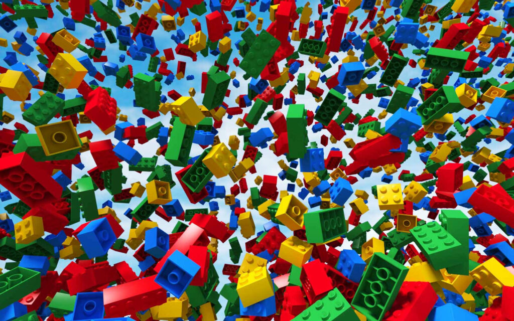 Colorful Lego bricks swirling on bright sky blue background vibrant playful wallpaper design