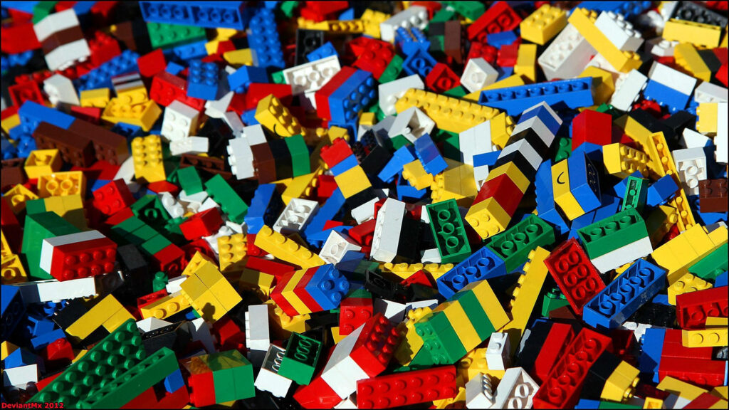Colorful Lego bricks scattered in a playful arrangement vibrant creative wallpaper background