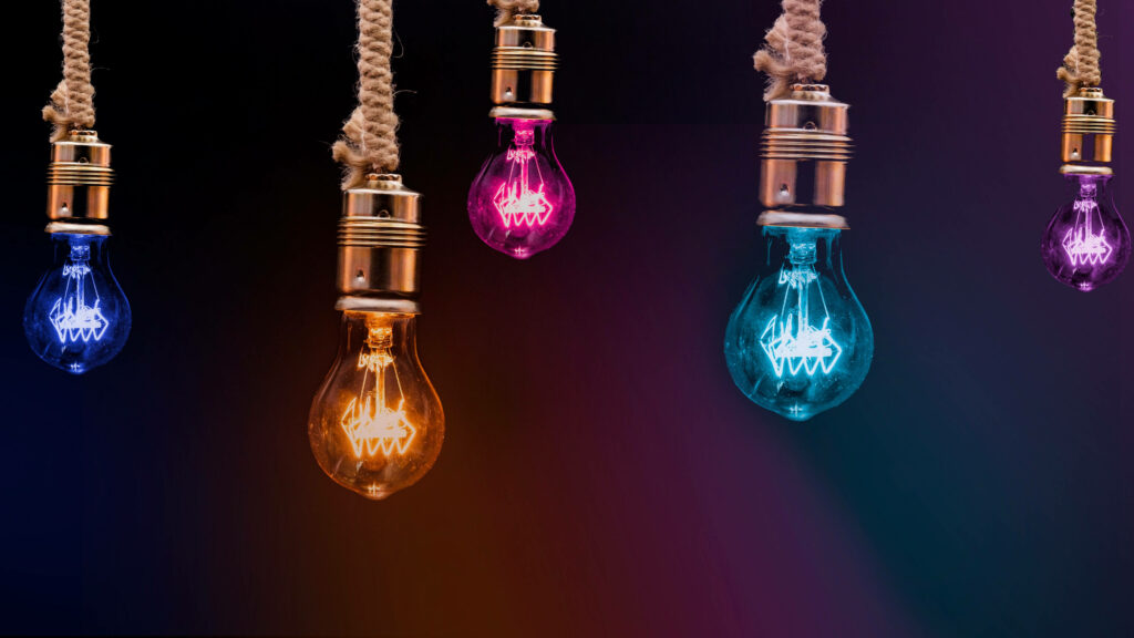 Colorful Hanging Light Bulbs Wallpaper on Dark Background