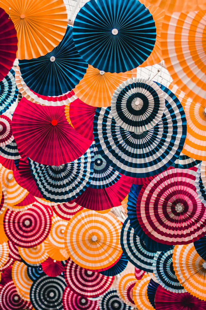 Vibrant Hanging Paper Parasols: Bold Patterns & Colors Background Wallpaper