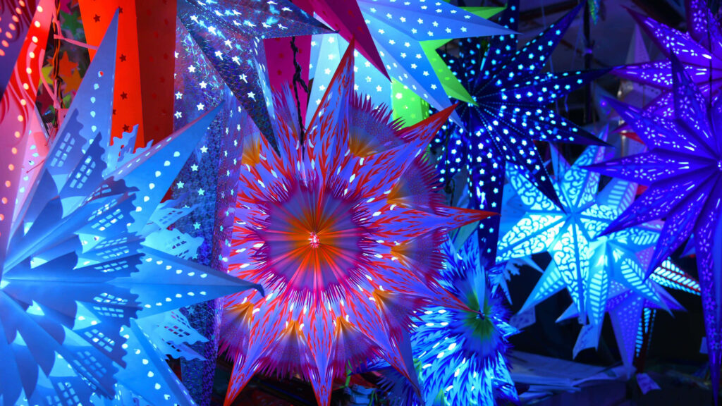 Vibrant Colorful Paper Stars Wallpaper: Festive, Illuminated Background