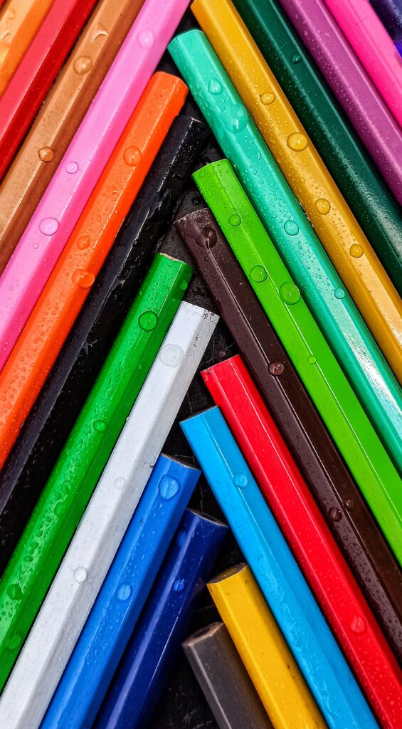 Colorful Pencils with Water Droplets: Vibrant Wallpaper Background