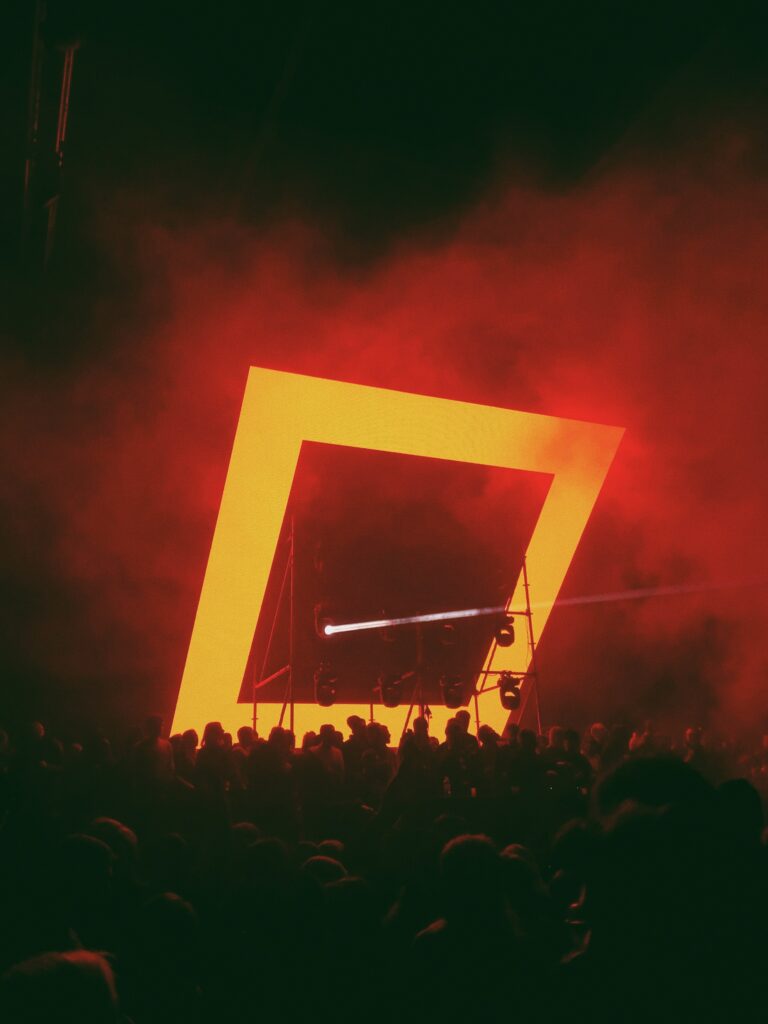 Vibrant Neon Frame Wallpaper: Concert Crowd in Red & Orange Hues
