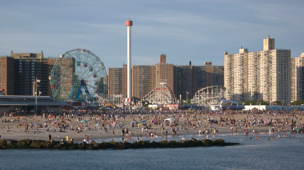 Coney Island Beach Wallpaper: Amusement Rides & Lively Shoreline