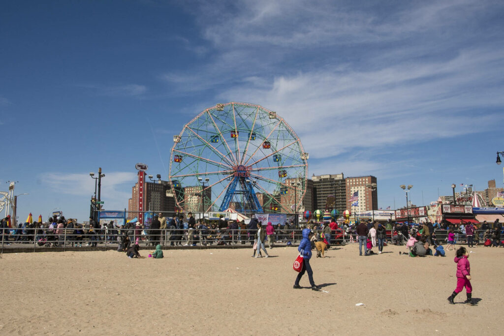Vibrant Coney Island Beach Wallpaper: Fun, Sun, and Amusement Rides