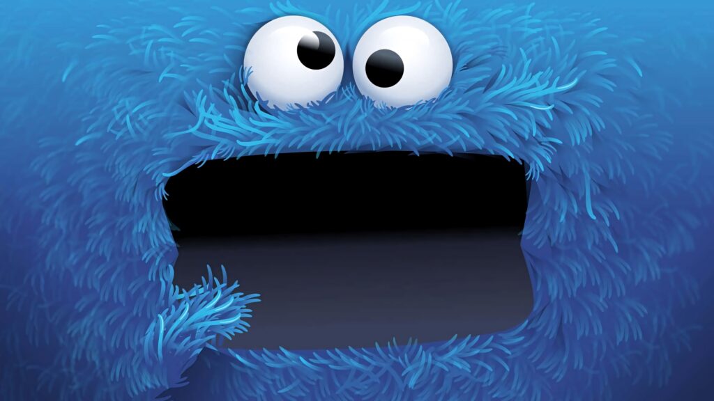 Close-up of playful Cookie Monster with fluffy blue fur and googly eyes in cartoon wallpaper