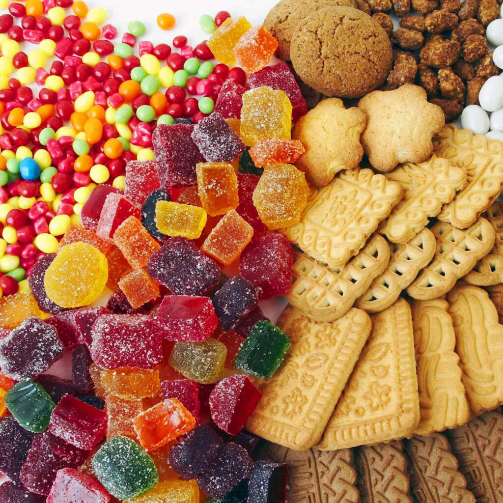 Colorful cookies gummy candies and sugar sweets mosaic wallpaper background vibrant and detailed