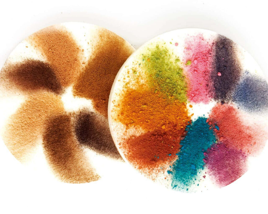 Vibrant cosmetics powders in circular pattern with bold brown blue pink and green shades wallpaper background