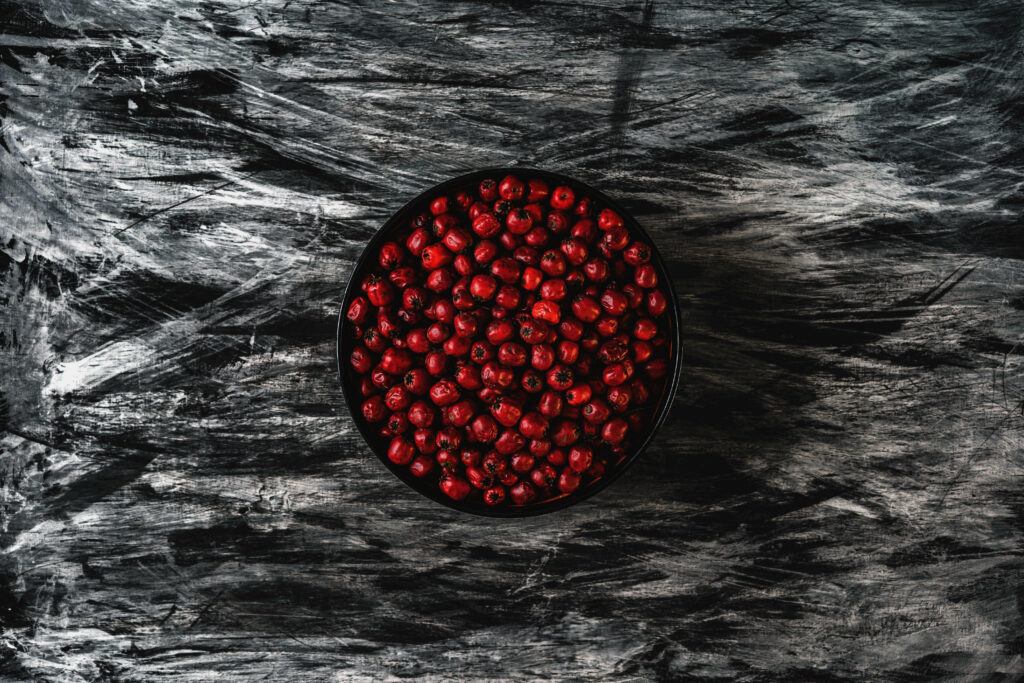 Vibrant Cranberry Bowl Desktop Wallpaper on Textured Background