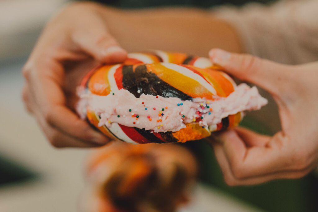 Colorful Cream-Filled Donut with Sprinkles - Artistic Wallpaper Background