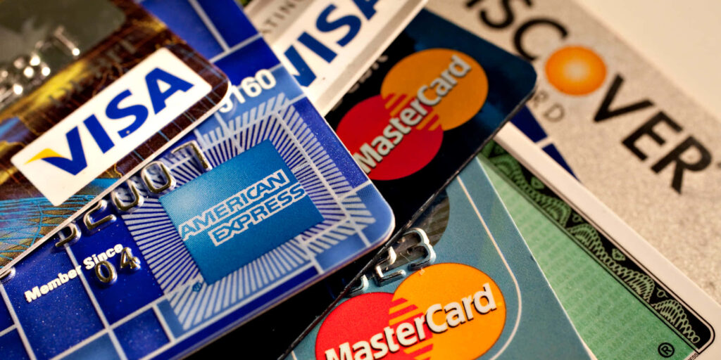Close up of colorful credit cards including Visa Mastercard Amex and Discover symbolizing finance choices Wallpaper
