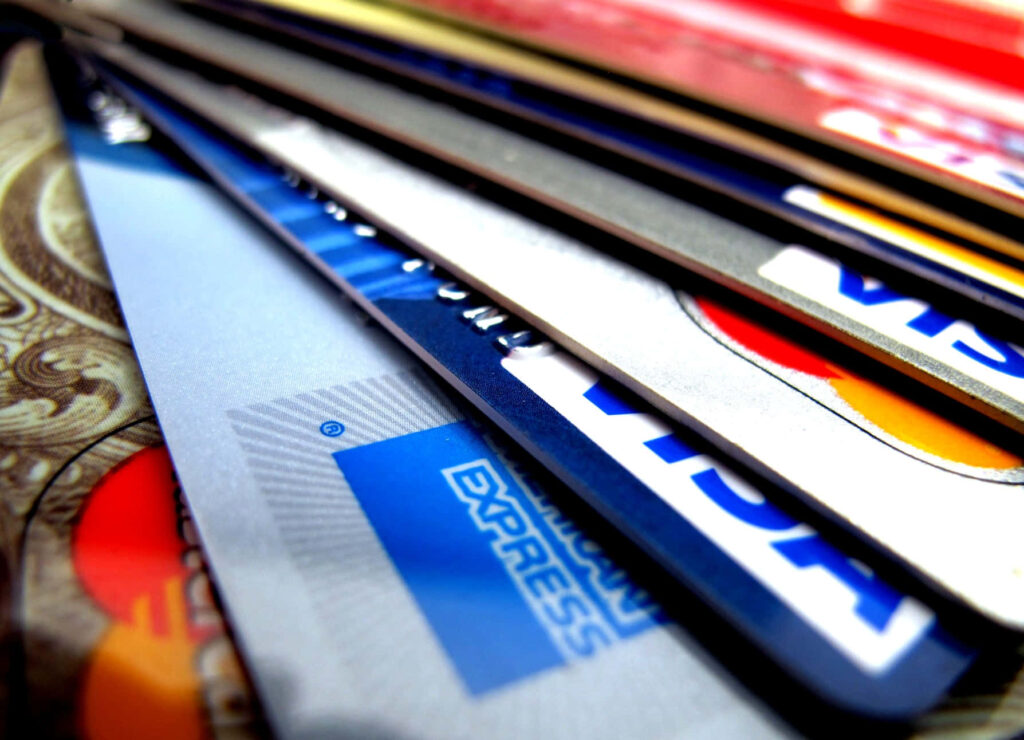 Close-up of colorful credit cards including Visa American Express and MasterCard representing finance Wallpaper