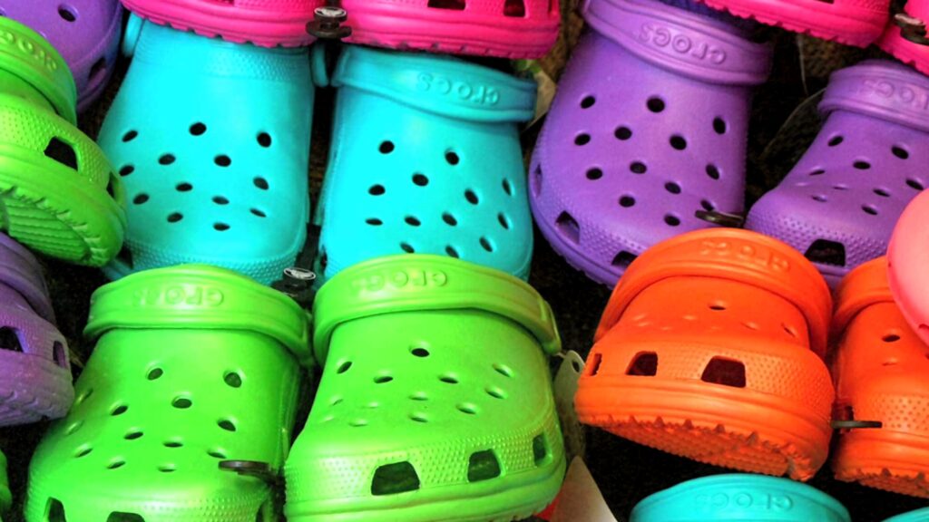 Vibrant colorful Crocs shoes wallpaper with green blue purple pink and orange playful design