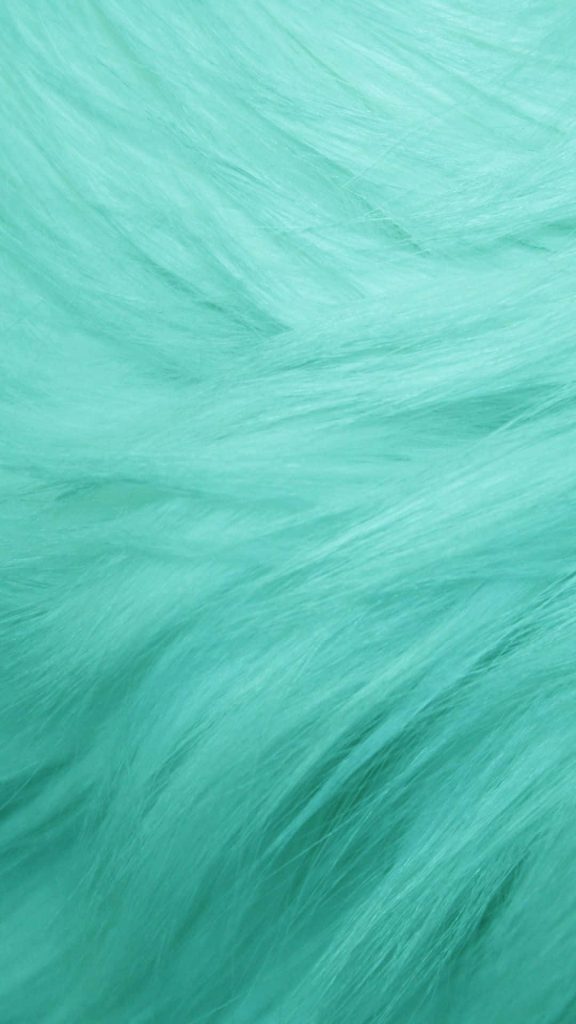Close-up of vibrant cyan mint faux fur with soft silky fibers for modern desktop wallpaper
