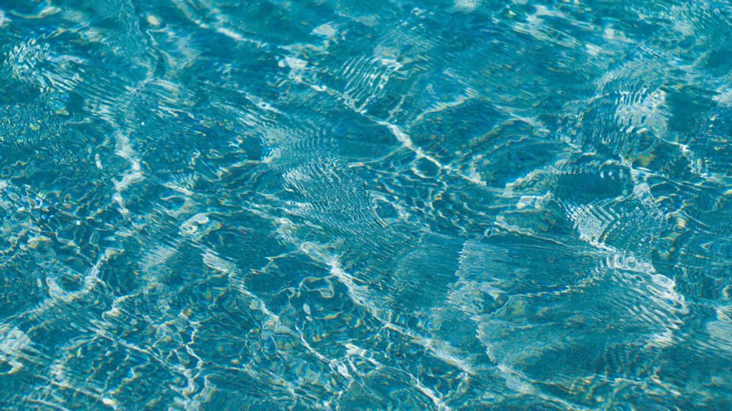 Vibrant cyan water ripples with light refraction on turquoise surface minimalist wallpaper background