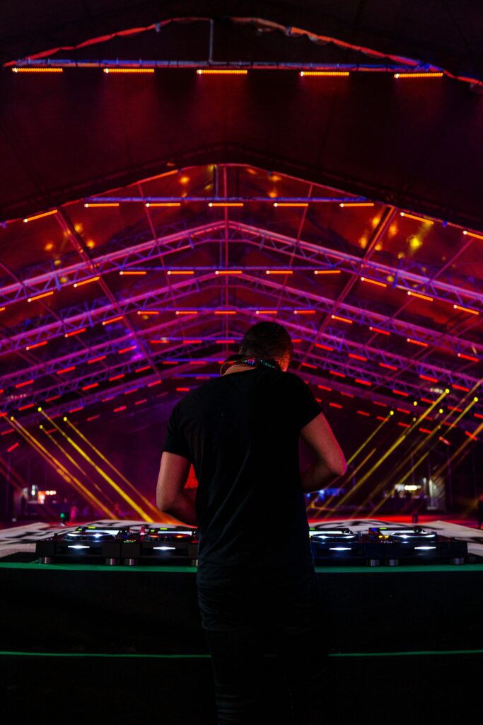 Electrifying DJ Club Wallpaper: Colorful Lights & Dynamic Atmosphere