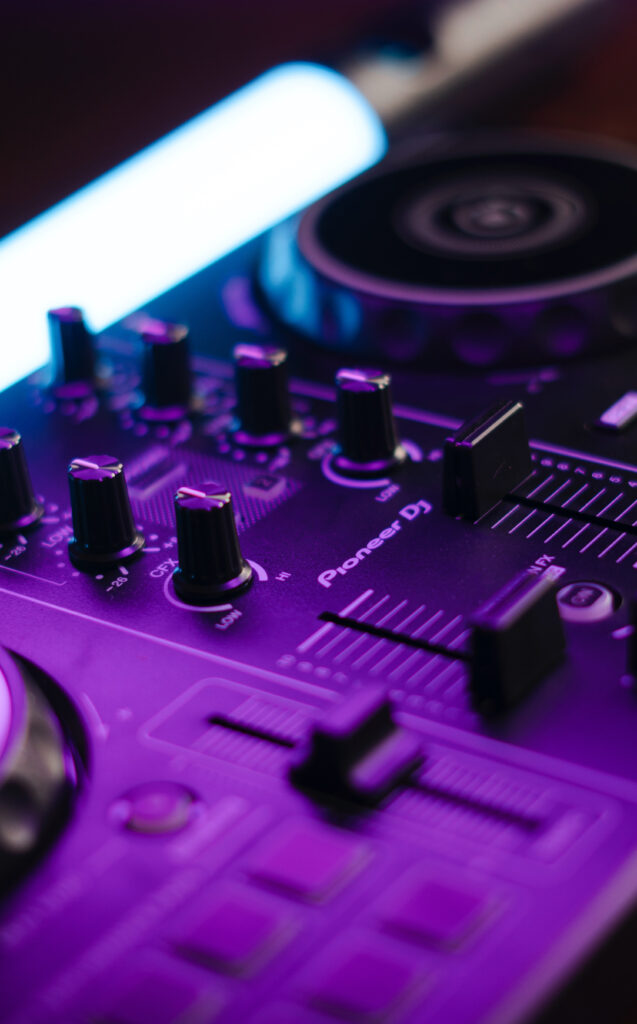 Electrifying DJ Controller Wallpaper with Purple Backlight