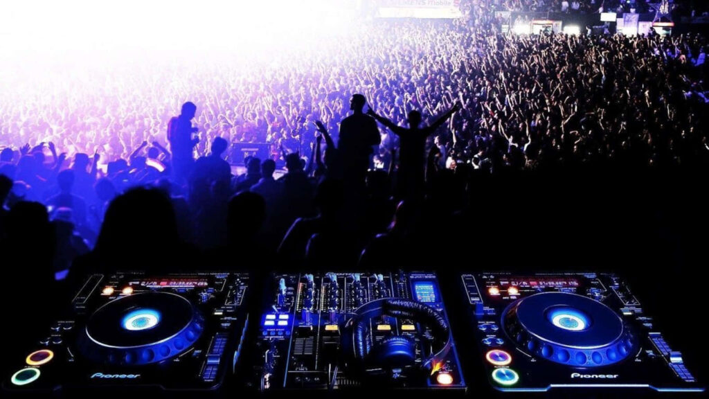 Vibrant DJ Set Wallpaper: Energetic Concert Scene with Colorful Lights