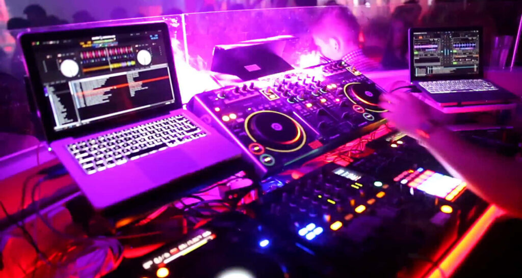 Vibrant DJ Setup & Colorful Lights: Electrifying Party Wallpaper