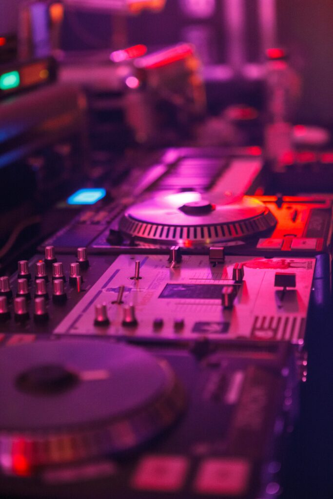 Vibrant DJ Setup Wallpaper: Energizing Mixer & Turntables Glow