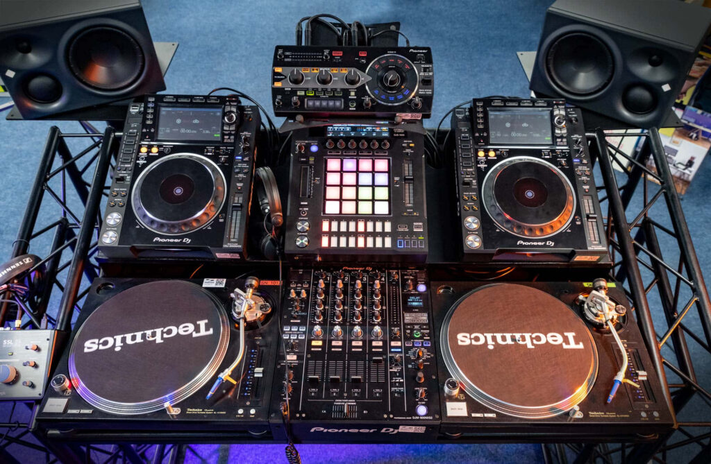 High-Energy DJ Setup with Technics Turntables & Pioneer Gear Wallpaper