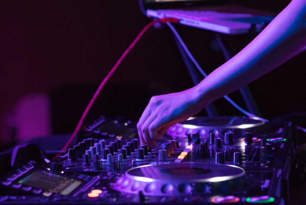 Dynamic DJ Wallpaper: Vibrant Club Scene with Mixing Console