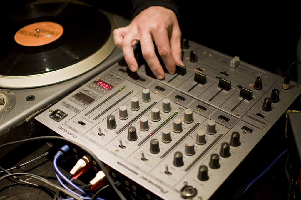 Vibrant DJ Wallpaper: Precision Mixing on Turntable & Console