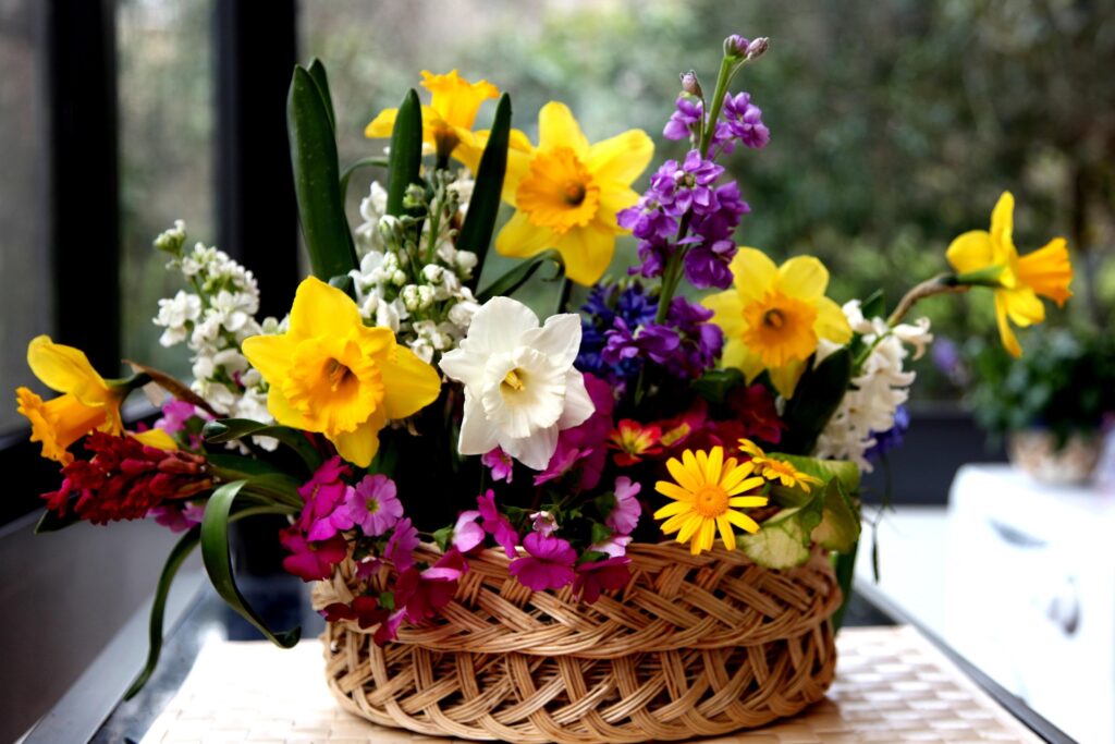 Vibrant Daffodils & Colorful Flowers in Woven Basket Wallpaper