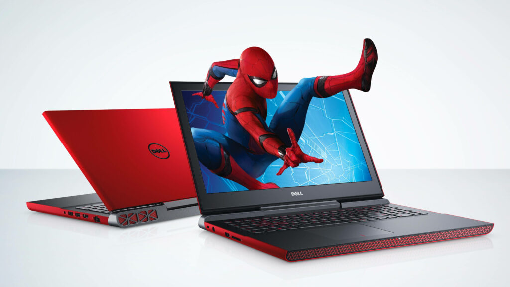 Two red Dell laptops with Spider-Man leaping from screen vibrant tech wallpaper background