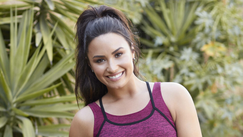 Demi Lovato Smiling Wallpaper: Vibrant Greenery & Natural Charm