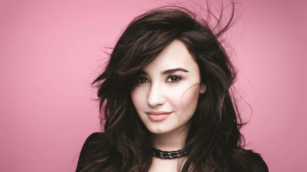 Vibrant Demi Lovato Wallpaper: Tousled Hair & Pink Elegance
