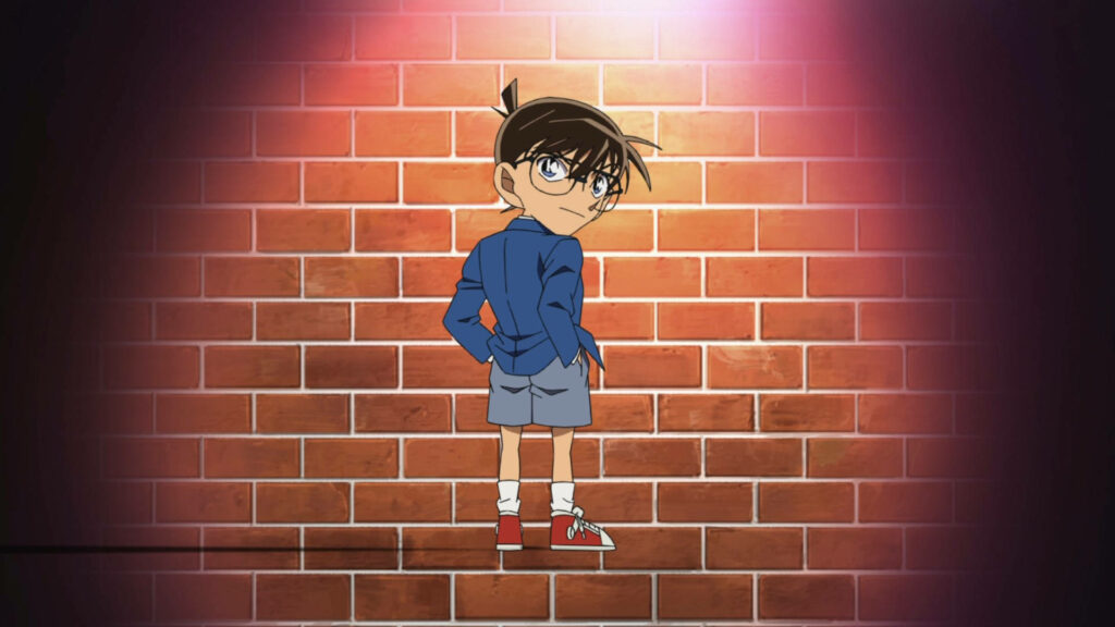 Detective Conan Wallpaper: Young Detective in Spotlight Against Brick Wall
