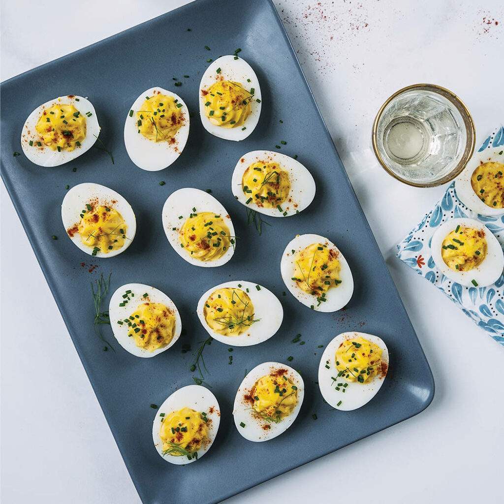 Vibrant Deviled Eggs Wallpaper: Flavorful Presentation on Dark Tray