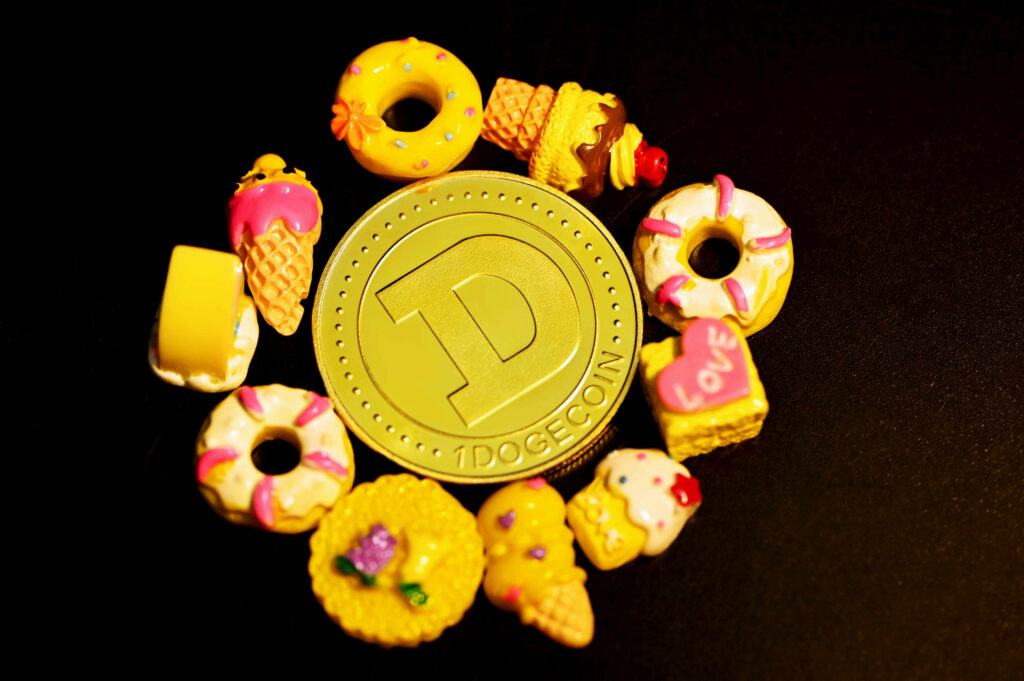 Vibrant Dogecoin coin surrounded by colorful sweets like donuts ice cream and cakes on black background Wallpaper