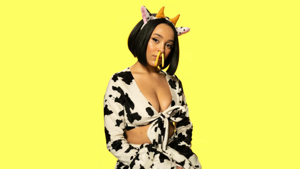 Vibrant Doja Cat Cow-Print Wallpaper with Playful Accessories