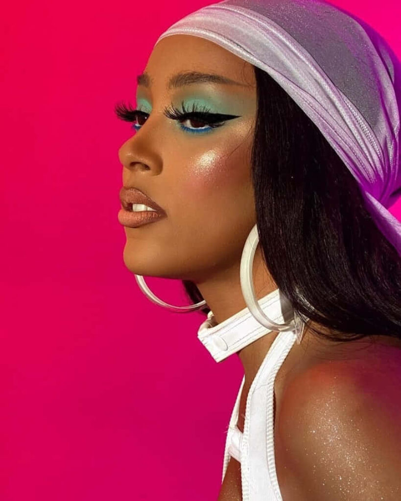 Vibrant Doja Cat Wallpaper: Bold Makeup & Accessories on Pink Background
