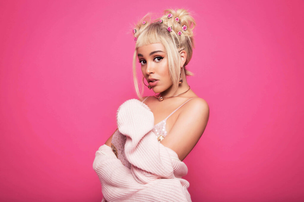 Vibrant Doja Cat Wallpaper: Bright Pink Background & Pearl Accents