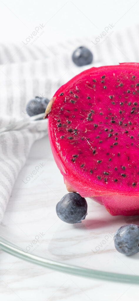 Vibrant Dragonfruit Close-Up Wallpaper with Blueberries Background
