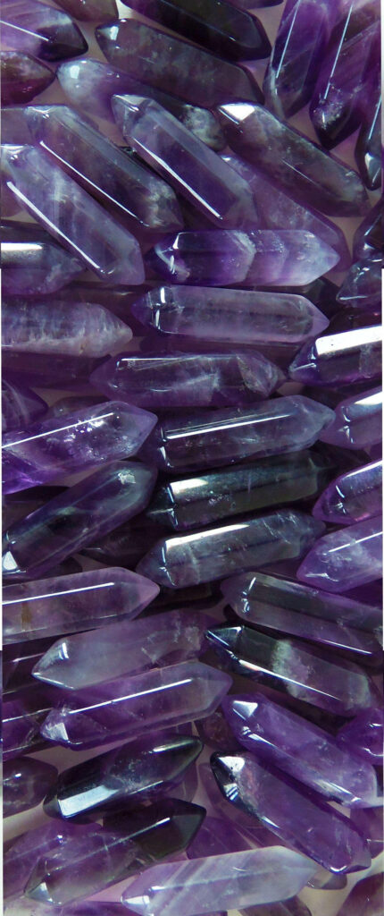 Dual-pointed amethyst crystal rods wallpaper with vibrant purple hues and natural clarity background