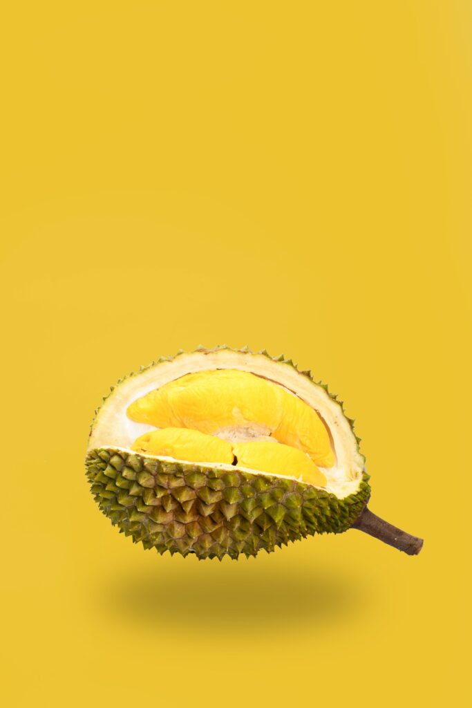 Exotic Durian Fruit Wallpaper: Spiky Green and Rich Yellow Design