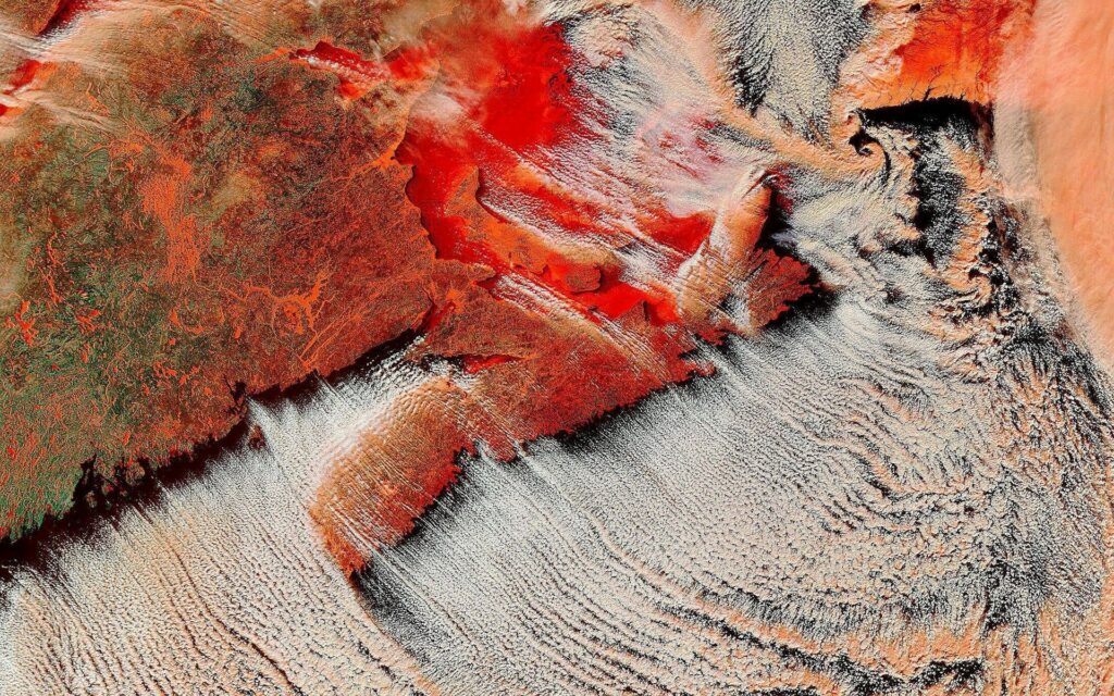 Vivid Earth Wallpaper: Fiery Eruption Meets Dramatic Cloud Textures