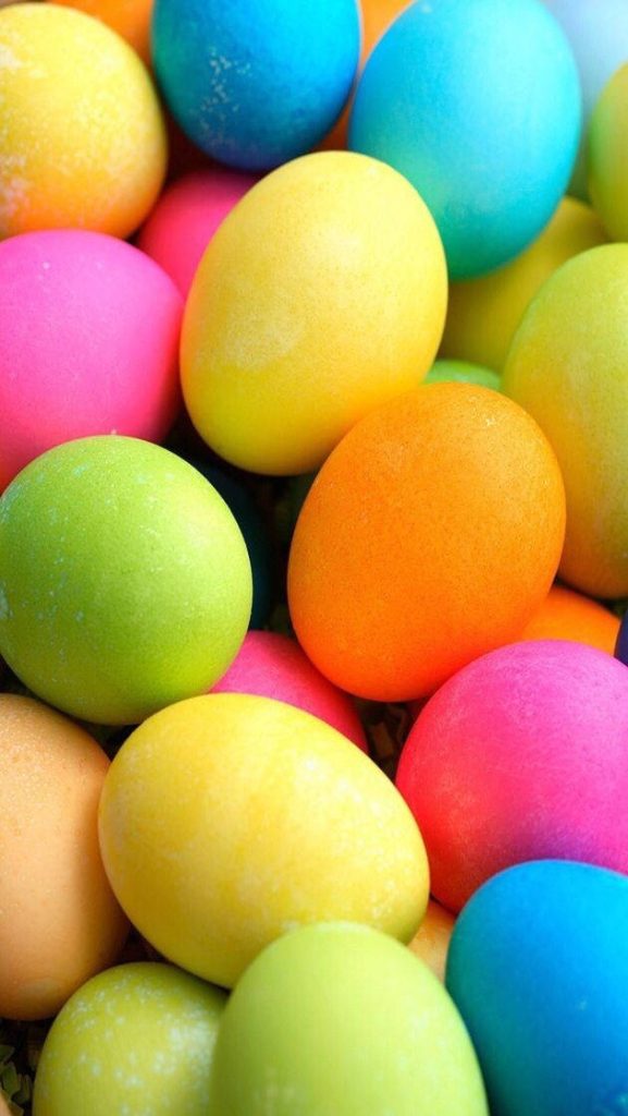 Colorful close-up of dyed Easter eggs in a vibrant rainbow palette brightening mobile wallpaper