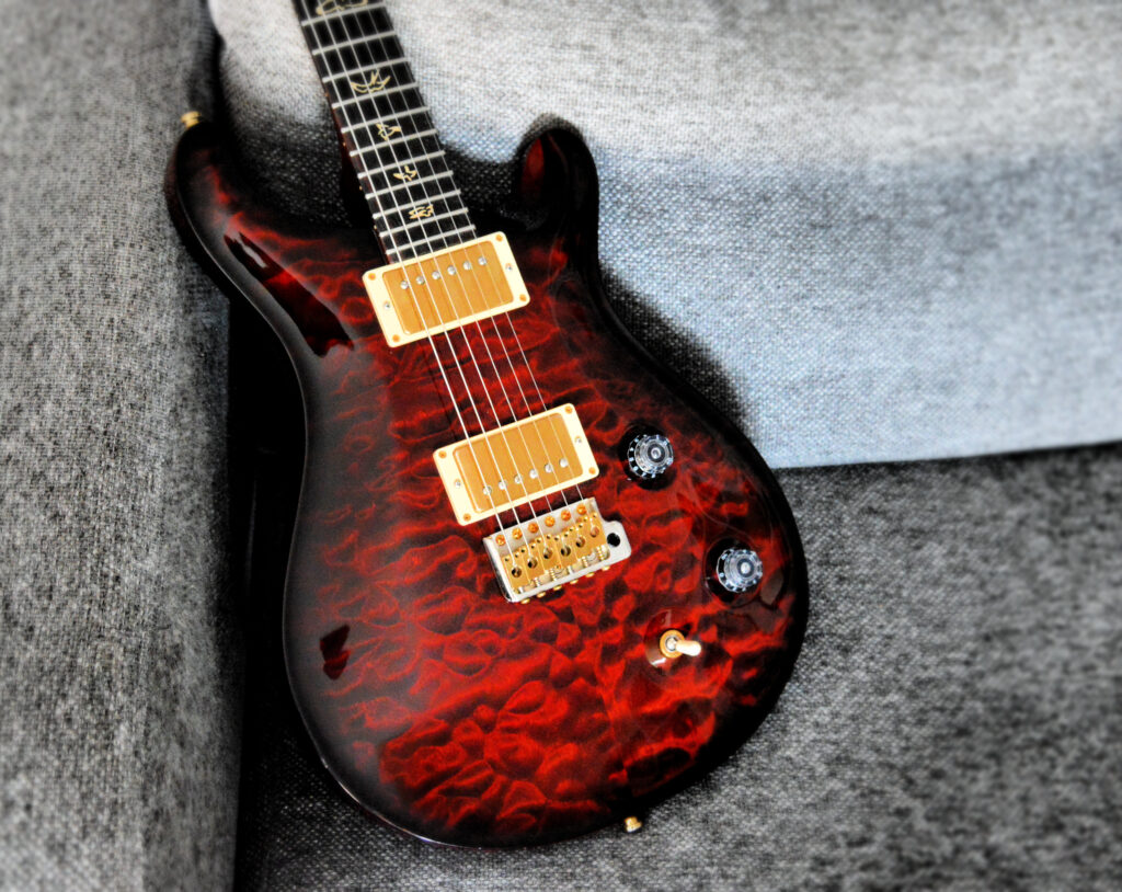 Vibrant Red-Orange Electric Guitar Wallpaper Background