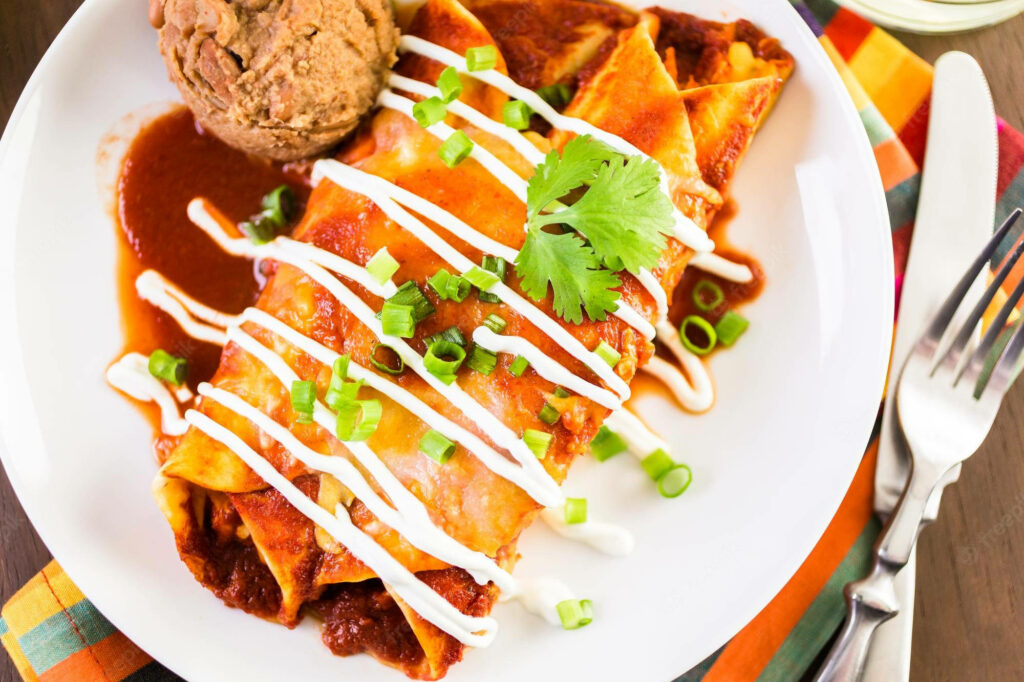 Vibrant Enchiladas Wallpaper: Colorful Dish with Refried Beans