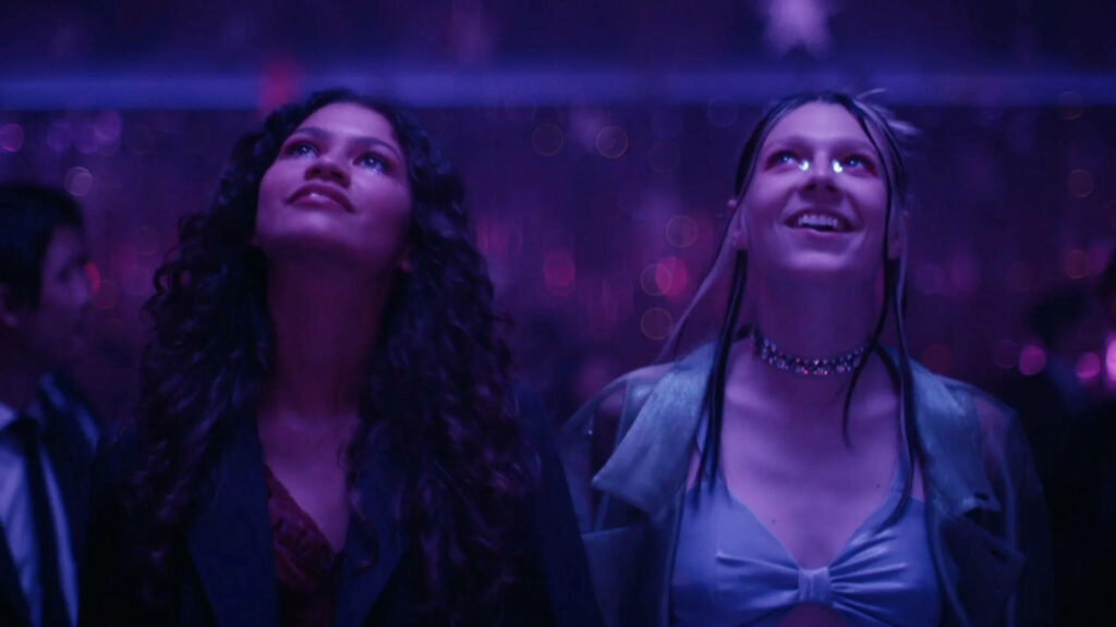 Colorful Euphoria Wallpaper: Rue & Jules Smiling Under Party Lights