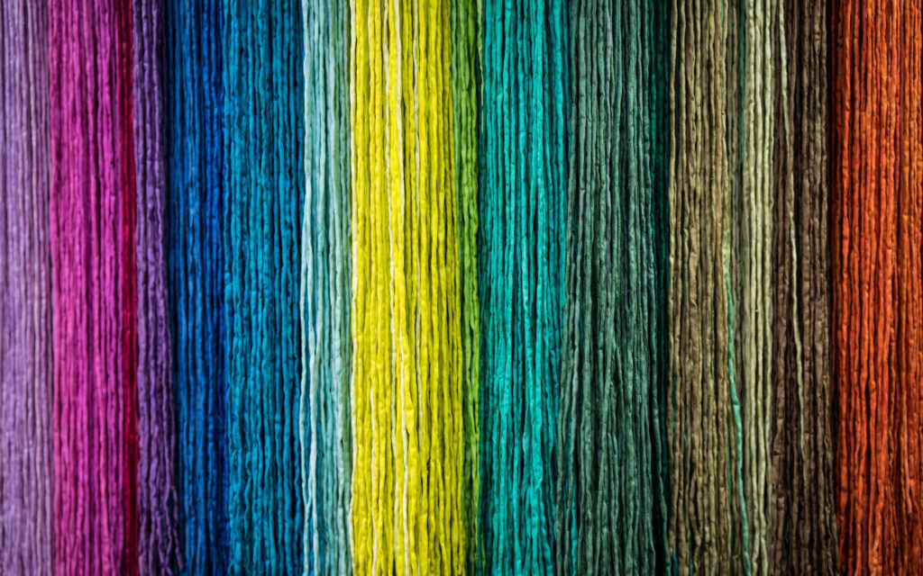 Colorful Fabric Textures Wallpaper Background: Vibrant Strings in Hues