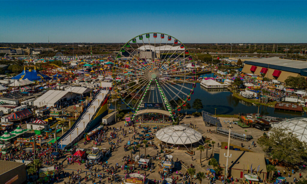 Vibrant Fairground Aerial View: Colorful Rides & Ferris Wheel Wallpaper