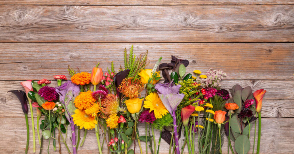 Vibrant Fall Flowers on Rustic Wooden Background - Stunning Wallpaper